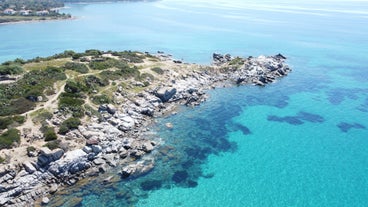 photo of an aerial view of Cagliari, in Sardinia, Italy, with the Montelargius lake and Quartu Sant Elena in the background.