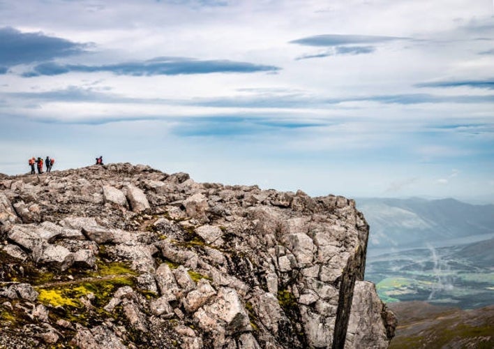 A group of hikers standing at the summit of Ben Nevis.jpg