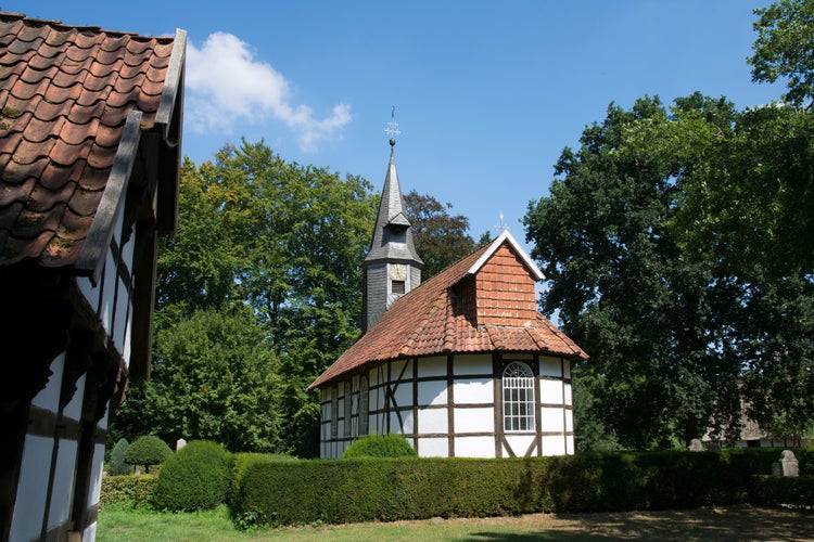 Church and house in Museumdorf Cloppenburg (Germany)