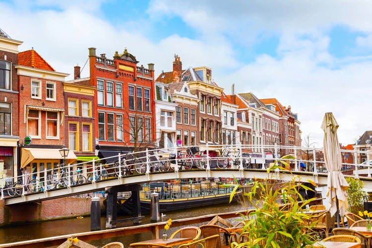 Traditional dutch houses near canal, bridge and bicycles in downtown of Leiden, Holland