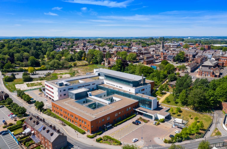 Aerial photo of the Pontefract Hospital located in the village of Pontefract in Wakefield in the UK on a sunny summers day showing the Hospital and grounds with a blue sky and white clouds in the sky