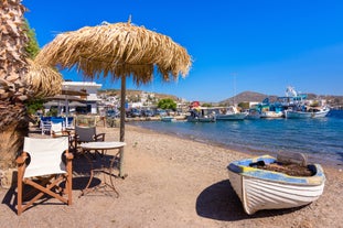 Photo of white boat in crystal clear blue sea water, Argostoli, Greece.