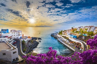 Photo of aerial view with Puerto de la Cruz, in background Teide volcano, Tenerife island, Spain.