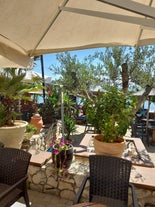 photo of umbrellas and chairs on the beach in Nea Flogita in Halkidiki, Greece.