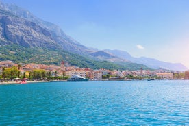 Photo of panorama and landscape of Makarska resort and its harbour with boats and blue sea water, Croatia.