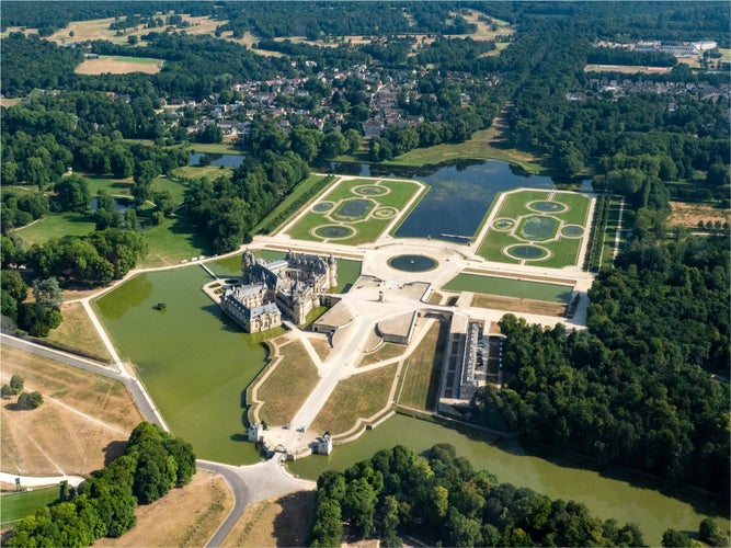 Photo of aerial view of the castle of Chantilly in the department of Oise in France.