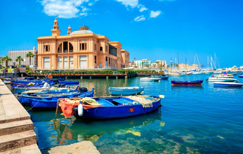 Margherita Theater and fishing boats in old harbor of Bari, Puglia, Italy. Bari is the capital city of the Metropolitan City of Bari on the Adriatic Sea, Italy. Architecture and landmark of Italy.