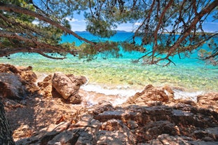 Photo of panorama and landscape of Makarska resort and its harbour with boats and blue sea water, Croatia.