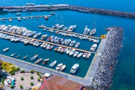 photo of aerial panorama of high cliffs, Tyrrhenian Sea Bay with pure azure water, floating boats and ships, pebble beaches, rocky surroundings of Meta in Sant'Agnello and Sorrento cities near Naples region in Italy.