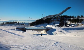 Photo of landscape with mountains, river and buildings in Lillehammer town, Norway.