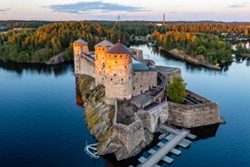 Aerial view of the Tampere city at sunset. Tampella building. View over Tammerkoski river in warm sunlight.