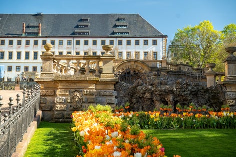 Photo of Castle Friedenstein in Gotha with flowers in front .
