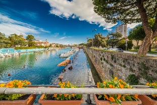 Photo of Cervia's canal, where the Salt Museum is located, with reflections on the water ,Italy.