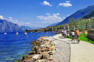 Photo of aerial view of superb Malcesine Mediterranean cityscape with colorful buildings and boats, yachts in the bay, lake Garda, Italy.