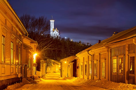 photo of small Swedish European town Soderhamn at night with Oscarsborg.