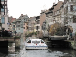 Photo of traditional half-timbered houses on picturesque canals in La Petite France in the medieval fairytale town of Strasbourg, France.