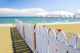 Photo of Umbrellas and sunbeds in San Felice Circeo, Italy.