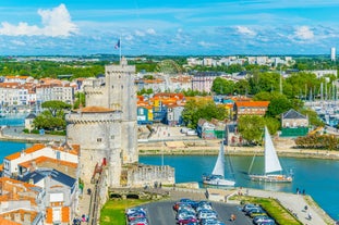 Photo of Vannes, beautiful city in Brittany, boats in the harbor, with typical houses and the cathedral in background, France.