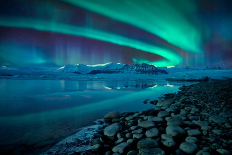 photo of northern lights over jökulsárlón glacier lagoon, Iceland.