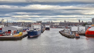 Photo of aerial view of Aberdeen as River Dee flows in a curve to the North Sea showing Duthie Park with bridge and traffic from south.