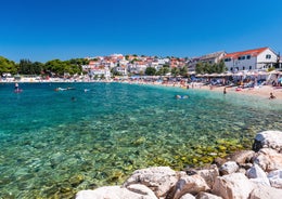 Photo of panorama and landscape of Makarska resort and its harbour with boats and blue sea water, Croatia.