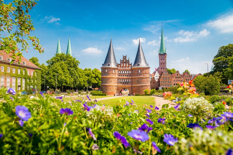 Classic postcard view of the historic town of Lübeck with famous Holstentor gate in summer, Schleswig-Holstein, northern Germany