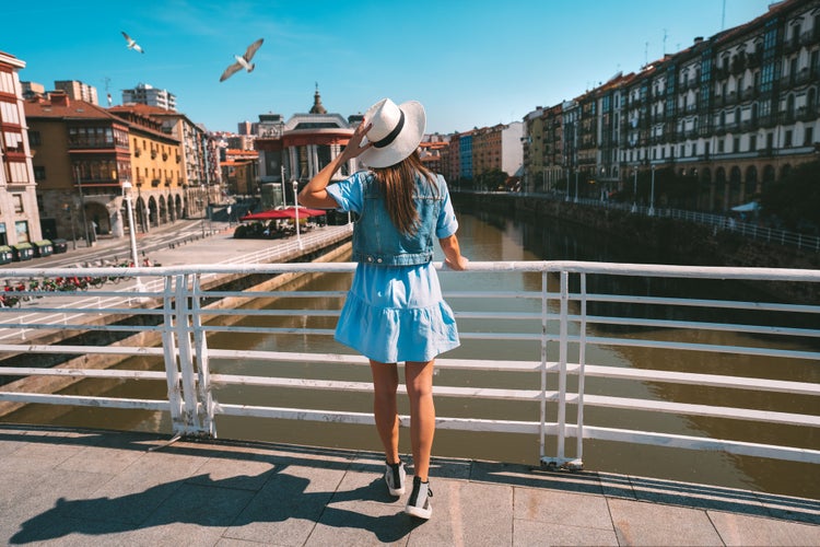 Photo of tourist woman walking in Bilbao city, summer holiday vacation in Spain.