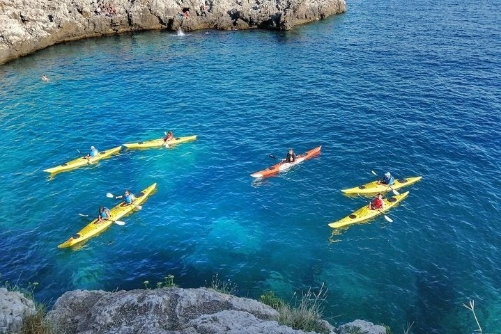 Exploring sea caves by kayak in Porto Selvaggio, a natural park in the Salento region of Italy..jpg
