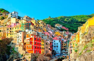 Photo of Riomaggiore with colorful houses along the coastline, one of the five famous coastal village in the Cinque Terre National Park, Liguria, Italy.