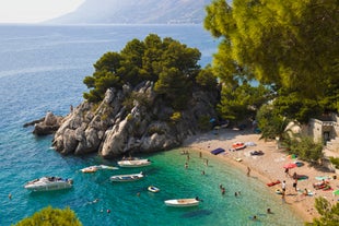 Photo of panorama and landscape of Makarska resort and its harbour with boats and blue sea water, Croatia.