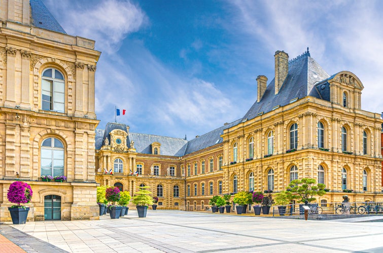 Amiens City hall Hotel de ville is a town hall neo-classical architecture style stone brick building with French flag in Amiens old historical city centre, Somme department, Hauts-de-France Region