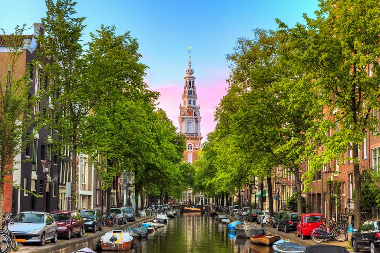 Beautiful Groenburgwal canal in Amsterdam with the Soutern church (Zuiderkerk) at sunset in summer.