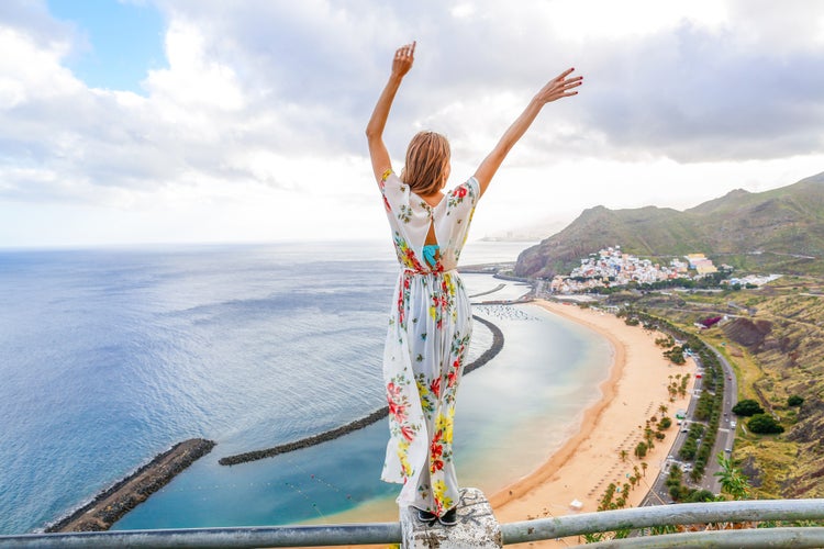 Photo of traveler girl enjoying the beach of Las Teresitas and San Andres village, Tenerife, Canary Islands, Spain. 