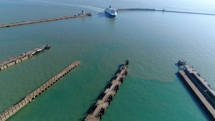 Photo of Aerial photo Dover harbor arriving ferry from English Channel is busiest seaway in world and connects Great Britain and mainland Europe sailing mainly to French ports such as Calais and Dunkirk .