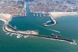 Porto, Portugal old town ribeira aerial promenade view with colorful houses, Douro river and boats.