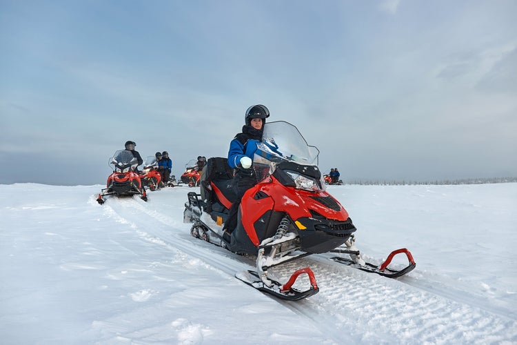 Photo of Riding on a snowmobile in Finland, female rider above the Arctic Circle