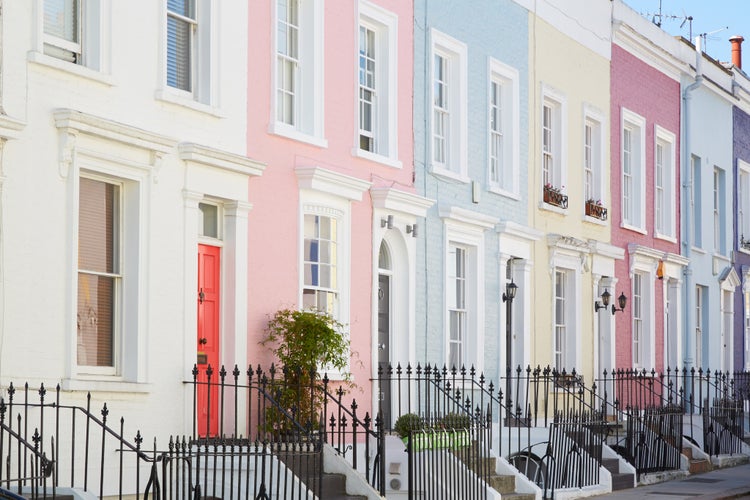 Photo of colorful English houses facades, pastel pale colors in London.