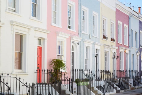 Photo of colorful English houses facades, pastel pale colors in London.