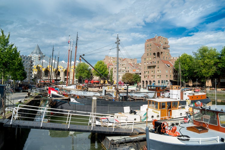 Rotterdam Holland - September 26th 2023: Yacht and boat seaport in Rotterdam centrum. Old harbor Cubehouses behind