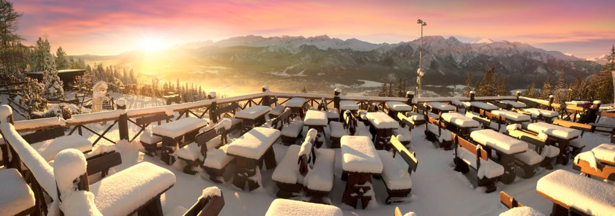 The snow lies on the tables of the café of the ski and tourist resort of the Polish city of Zakopane on the Gubałówka mountain, opposite the peak of the Tatras.