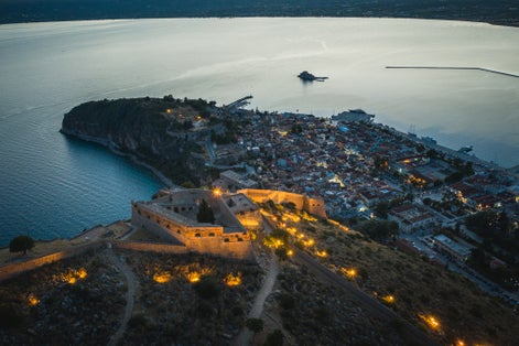 Photo of Nafplio aerial panoramic view of Palamidi fortress at night.