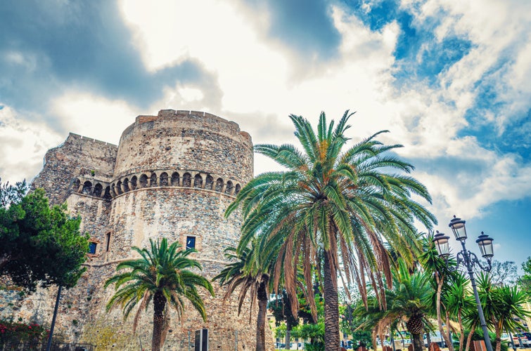 Aragonese Castle Castello Aragonese stone medieval buildings and palm trees in Piazza castello square in Reggio Calabria.