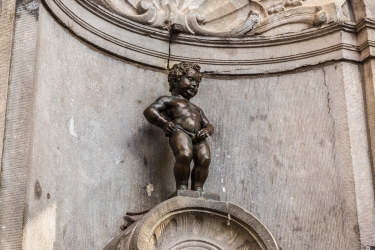 BRUSSELS, BELGIUM - JULY 6: Manneken Pis statue in Brussels. Statue of a pissing boy in a beautiful summer day in Brussels, Belgium on July 6 2014.