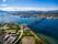 Photo of houses, bridge and panorama of Norwegian city Tromso beyond the Arctic circle from mountain in Norwegian fjords.