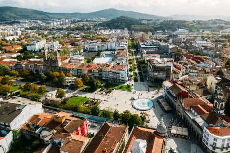Aerial view of Barcelos city, district Braga, Portugal. Landscape on the river Cavado, Barcelos bridge, Paco dos Condes, water mill and church.