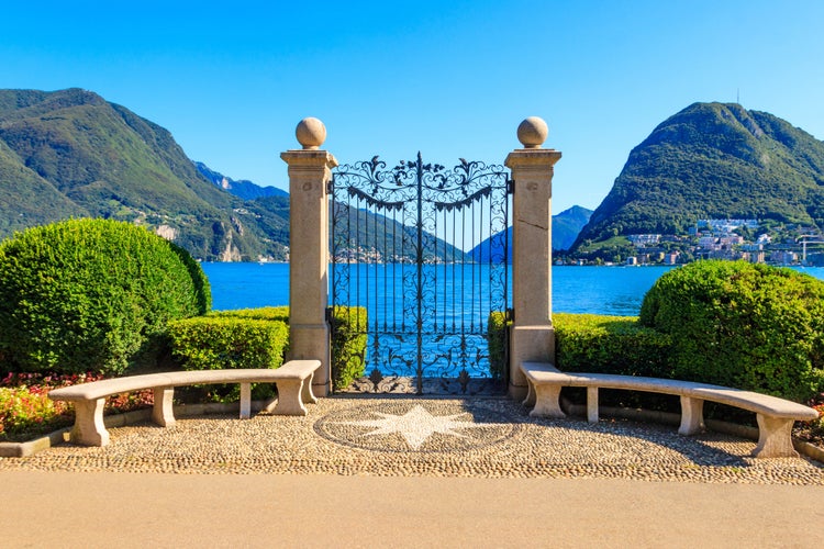 Photo of old wrought iron gate overlooking Lake Lugano in Ciani Park, Lugano, Switzerland.