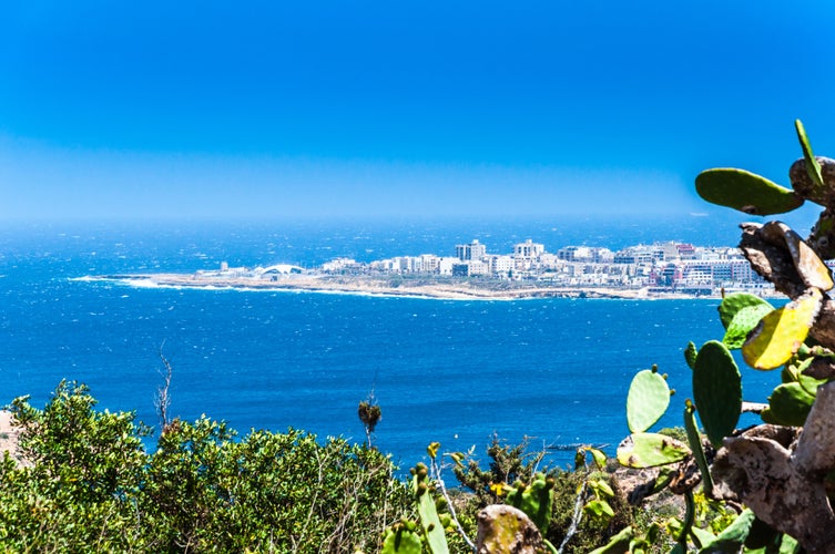 Photo of Qawra with beautiful beach view and blue sky, Malta.