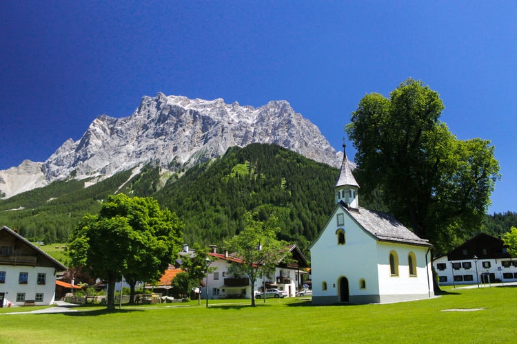 photo of church in Ehrwald village Austria view of near border of Germany highest mountain Zugspitze Alps.