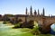 Photo of View of Zaragoza in sunny day. Ancient stone bridge and Cathedral.