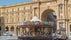 photo of view of Vintage carousel and tourists in Piazza della Repubblica (Republic Square) and the arch in honor of the first king of united Italy on background in Florence, Italy.